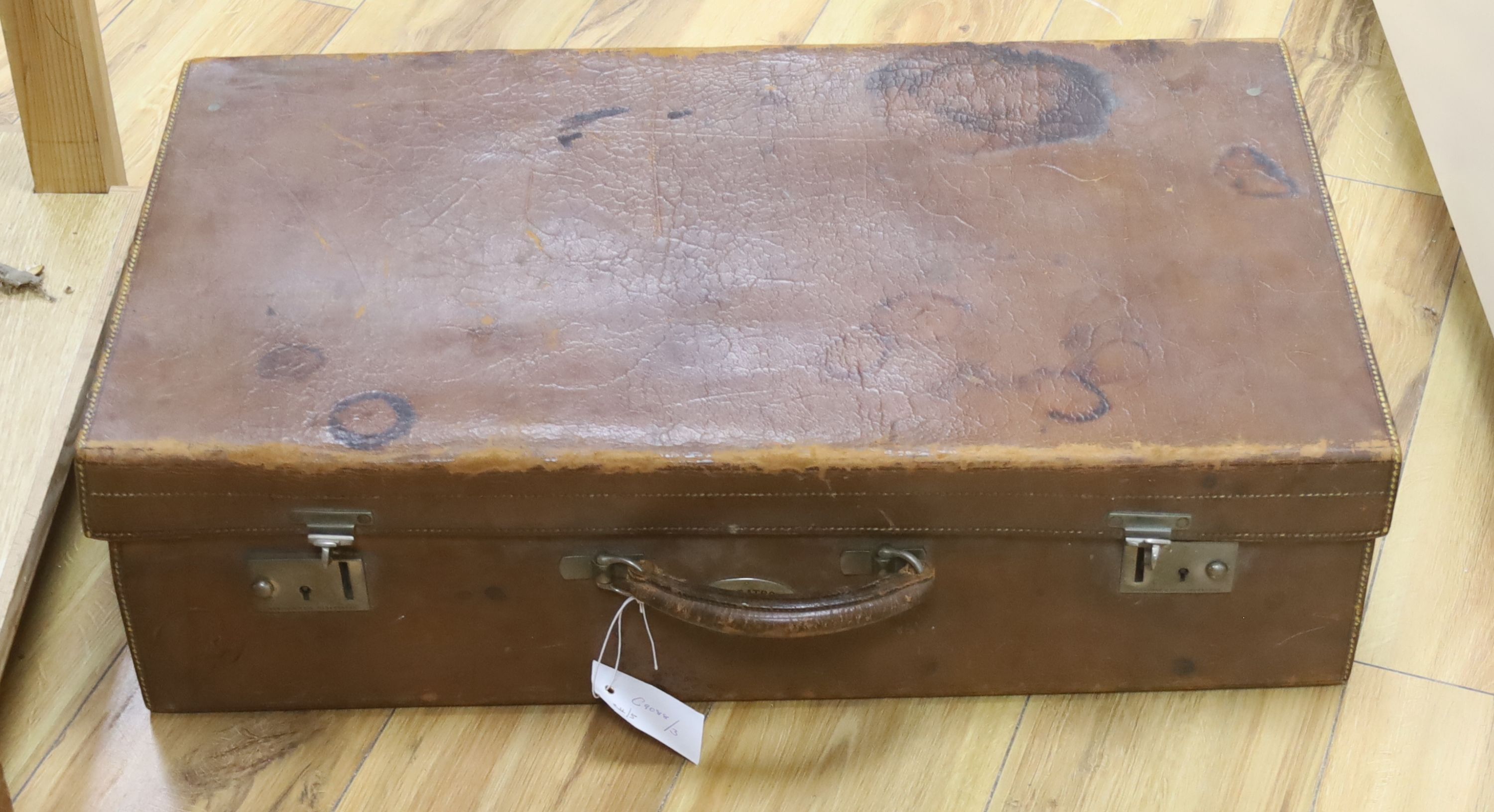 Finnigans of Manchester. A leather case fitted with silver mounted and ivory dressing accessories